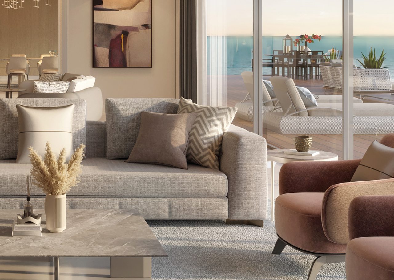Living room with sofas and full-height glass doors to the terrace and a sea view