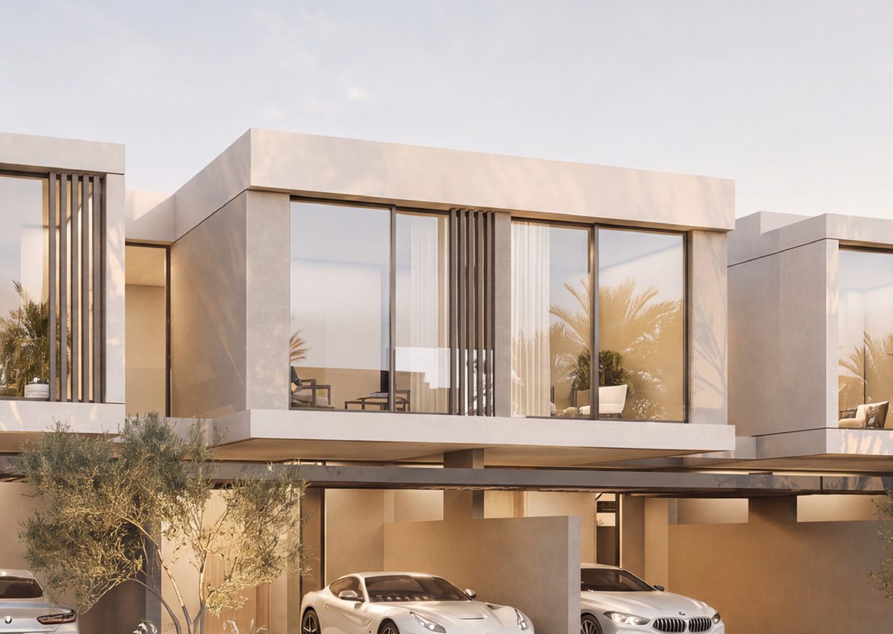 Front of a villa with a two-car parking space and a planted entrance